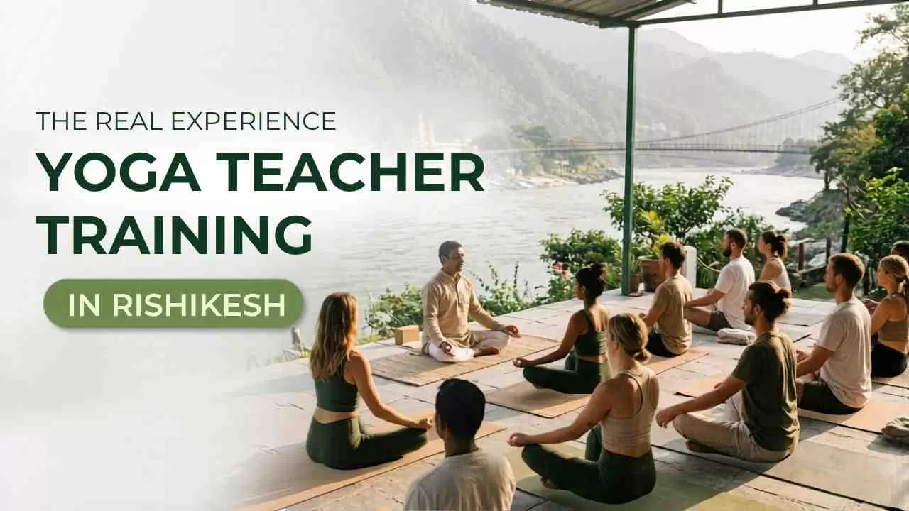 Students practicing yoga at sunrise beside the Ganga river during a Yoga Alliance certified teacher training course in Rishikesh, India.